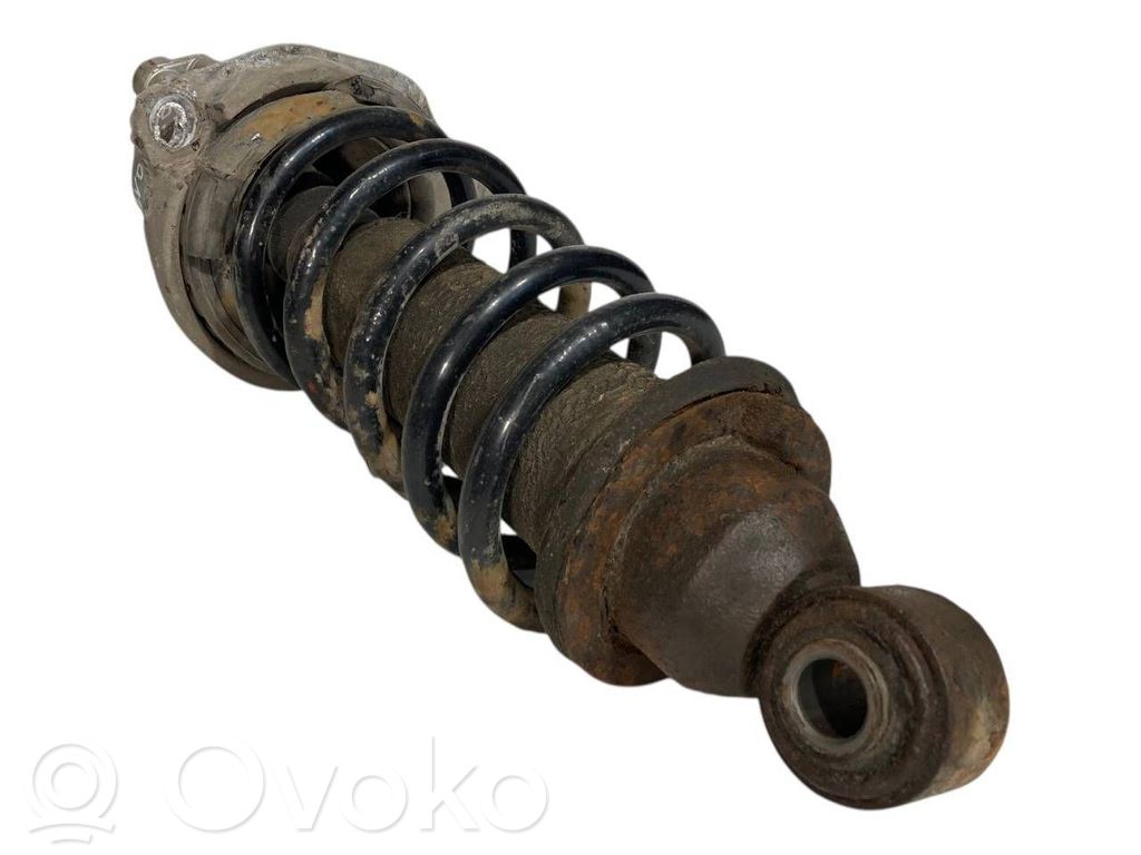 Aizmugurē amortizators ar atsperi