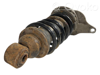 Aizmugurē amortizators ar atsperi